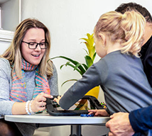 Female therapist working with child and father