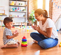 Female counsellor working with child using toys